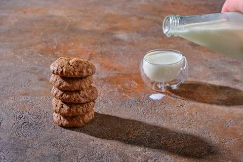 In the foreground, a stack of delicious homemade oatmeal cookies, in the di.. Stock Photos