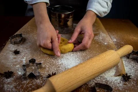 In the foreground is a table with baking parchment lying on it, on which there Stock Photos