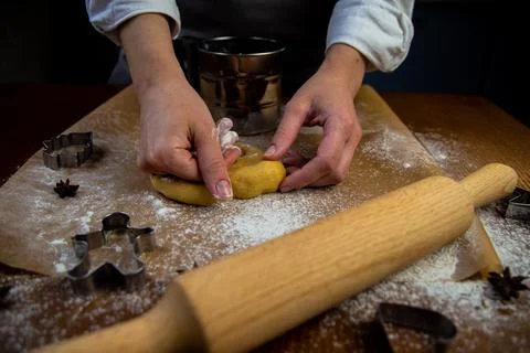 In the foreground is a table with baking parchment lying on it, on which there Stock Photos