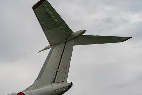Foreground view of a grey or light blue propeller aircraft, tail visible Cl.. 스톡 사진