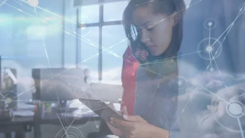 Foreground woman tapping tablet in tech hub, accessing cloud data with nodes Stock Footage 331005678