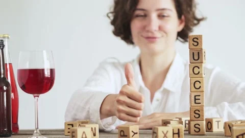 In the foreground is the word SUCCESS built from cubes. Portrait of a charmi Stock Footage 157235887