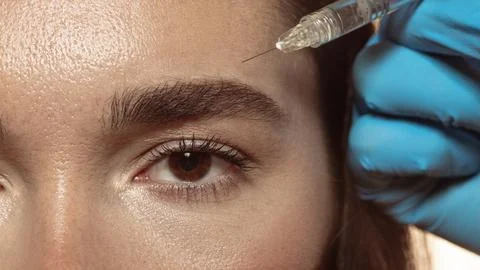 Forehead injection as aesthetic correction by professional dermatologist Stock Photos