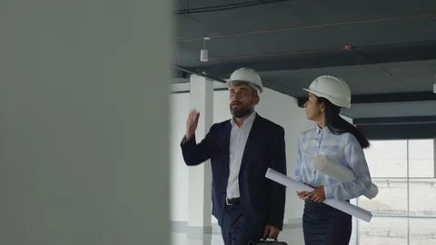 Foreign architects visiting new building under construction Stock Footage 125713526