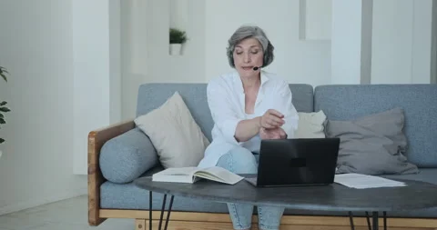 Foreign language senior teacher communicating with the student remotely via Stock Footage 159167121