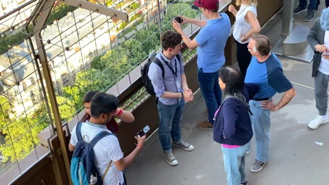 Foreign tourists taking a selfie in the Eiffel Tower in Paris, France Stock Footage 196153945