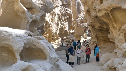 Foreign tourists visiting inside Chahkooh Canyon in Qeshm Island Iran Stock Footage 111668181