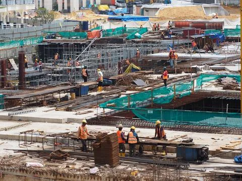 Foreign workers are working in a construction site Foto stock