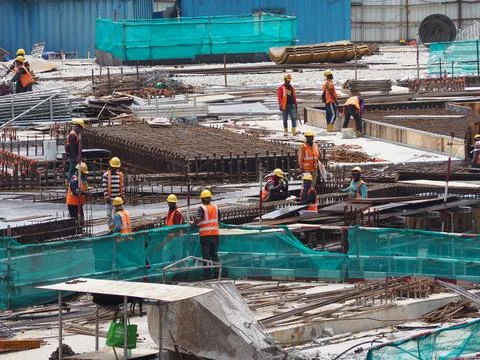 Foreign workers are working in a construction site Stock Photos