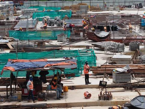 Foreign workers are working in a construction site Stock Photos