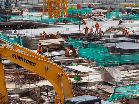 Foreign workers are working in a construction site Stock Photos