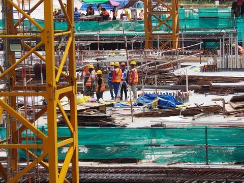 Foreign workers are working in a construction site Stock Photos