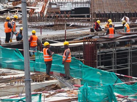 Foreign workers are working in a construction site Stock Photos