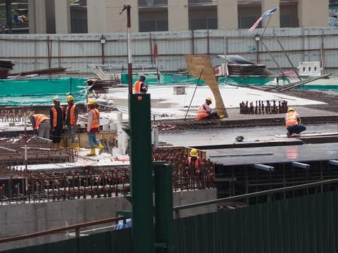 Foreign workers are working in a construction site Stock Photos