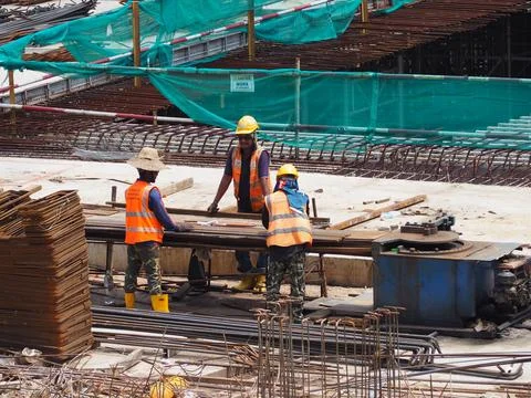 Foreign workers are working in a construction site Foto stock