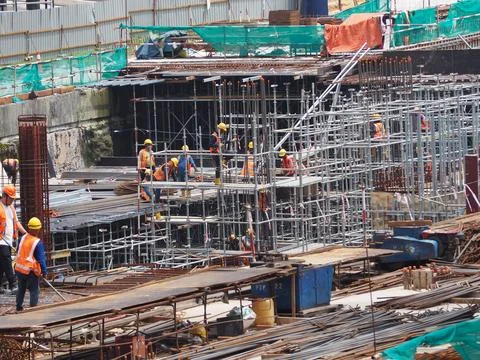 Foreign workers are working in a construction site Stock Photos