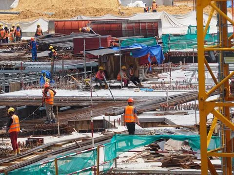 Foreign workers are working in a construction site Stock Photos