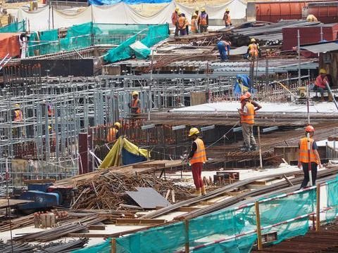 Foreign workers are working in a construction site Stock Photos