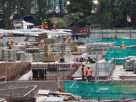 Foreign workers are working in a construction site Stock Photos