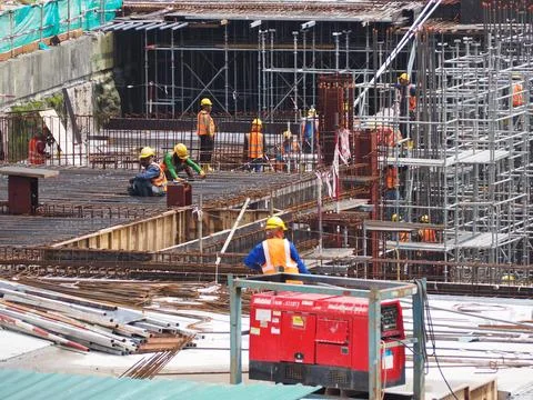 Foreign workers are working in a construction site Stock Photos