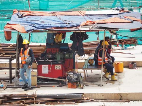 Foreign workers are working in a construction site Stock Photos