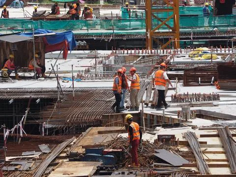 Foreign workers are working in a construction site Stock Photos