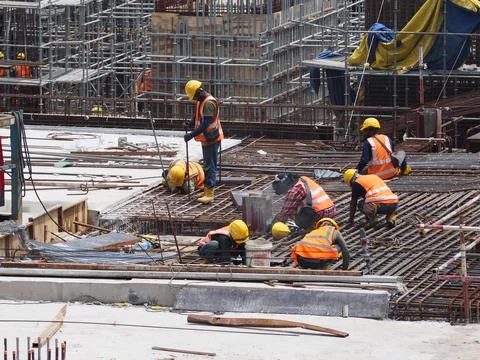 Foreign workers are working in a construction site Foto stock