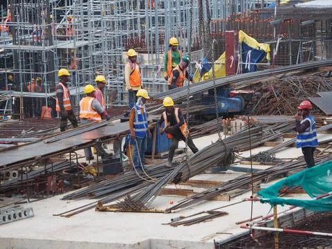 Foreign workers are working in a construction site Foto stock