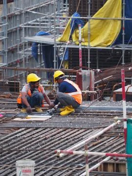 Foreign workers are working in a construction site Stock Photos