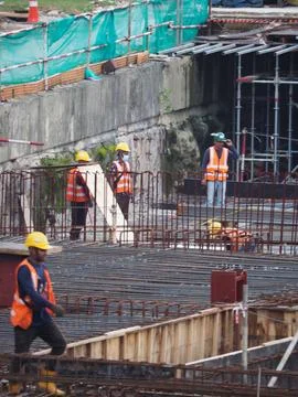 Foreign workers are working in a construction site Foto stock