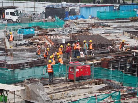 Foreign workers are working in a construction site Foto stock