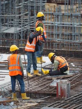 Foreign workers are working in a construction site Stock Photos
