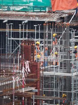 Foreign workers are working in a construction site Stock Photos