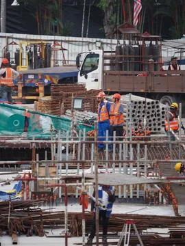 Foreign workers are working in a construction site Stock Photos