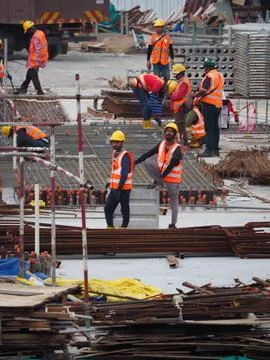 Foreign workers are working in a construction site Stock Photos
