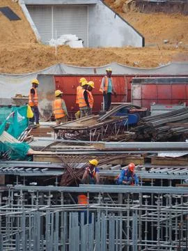 Foreign workers are working in a construction site Foto stock