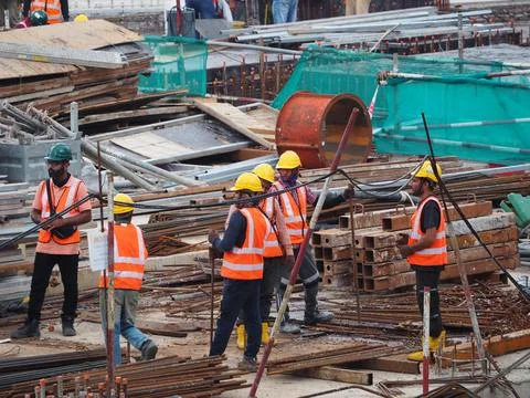 Foreign workers are working in a construction site Stock Photos