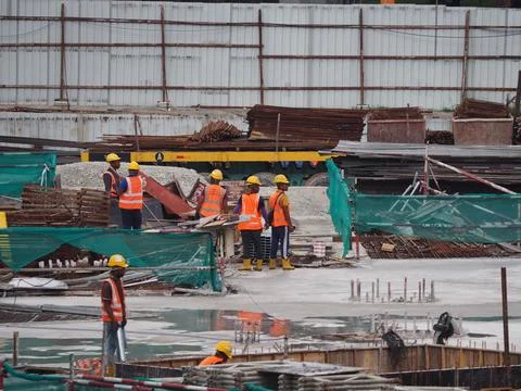 Foreign workers are working in a construction site Stock Photos