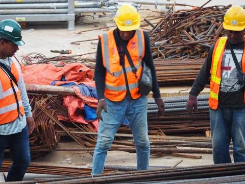 Foreign workers are working in a construction site Foto stock