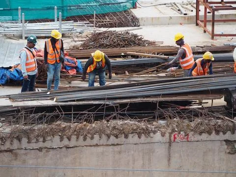 Foreign workers are working in a construction site Stock Photos