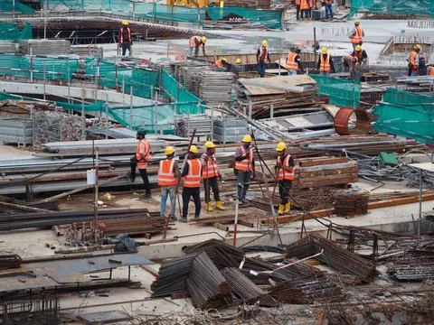 Foreign workers are working in a construction site Stock Photos