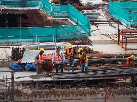 Foreign workers are working in a construction site Stock Photos