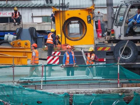 Foreign workers are working in a construction site Stock Photos