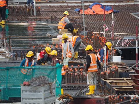 Foreign workers are working in a construction site Stock Photos