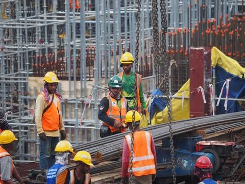 Foreign workers are working in a construction site Stock Photos
