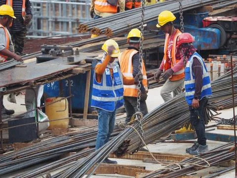 Foreign workers are working in a construction site Stock Photos