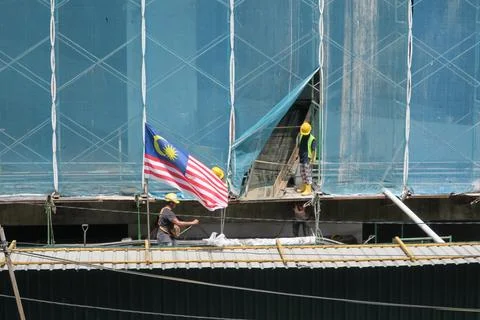 Foreign workers are working in a construction site Stock Photos