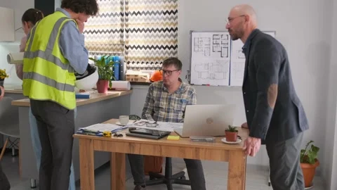 Foreman and architect arguing at office meeting about new project Stock Footage 316228334