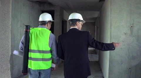 Foreman and architect go through construction site Stock Footage 65159872