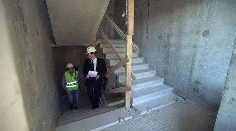 Foreman and architect going upstairs Stock Footage 65175121